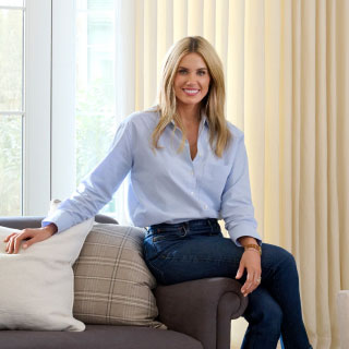 Portrait of Shea McGee seated in her living room promoting her new Studio McGee Collection for The Shade Store.