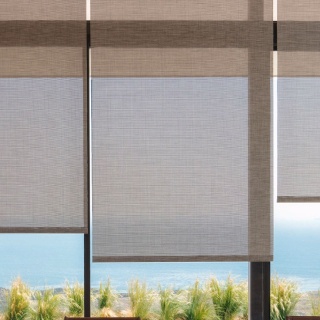 A stunning ocean view is framed by Solar Shades made of Naomi fabric in Honey.