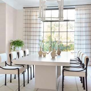 A dining room is finished with Tailored Pleat Drapery made from Victoria Hagan Lily embroidered plaid fabric in Silver.