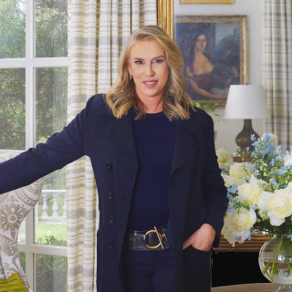 A portrait of the designer Victoria Hagan set against the backdrop of her home.