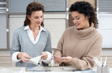 A Design Consultant reviewing fabric swatch options with a customer in a showroom during a free design consultation