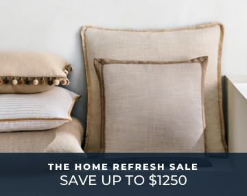Multiple Square Pillows stacked against a white wall featuring various styles in neutral colors with Home Refresh Sale text