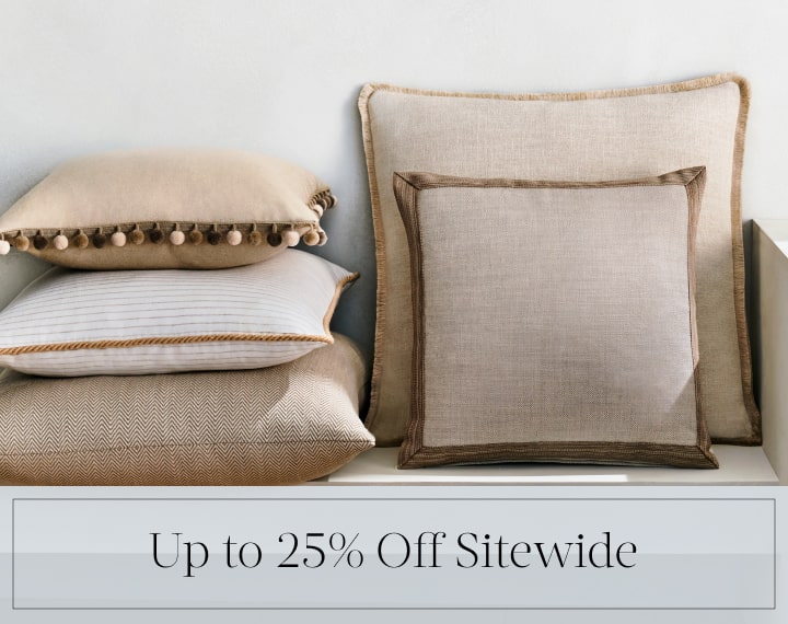 Up to 25% Off Sitewide in black text over an image of Square Pillows in neutral fabrics with trim.