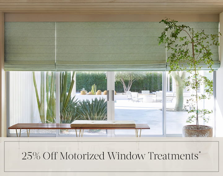 25% Off Motorized Window Treatments in black text over an image of living room windows with sage green Roman Shades.