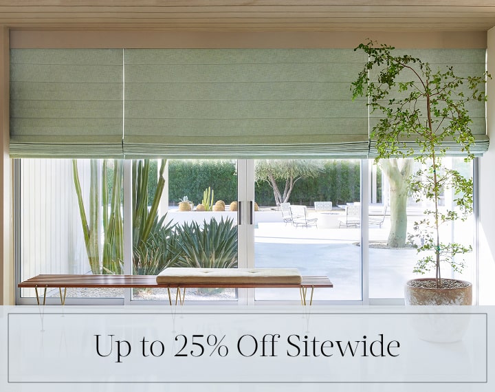 Up to 25% Off Sitewide in black text over an image of living room windows with sage green Roman Shades.